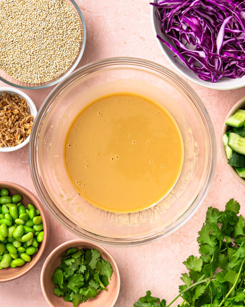 Miso dressing whisked together in a bowl.