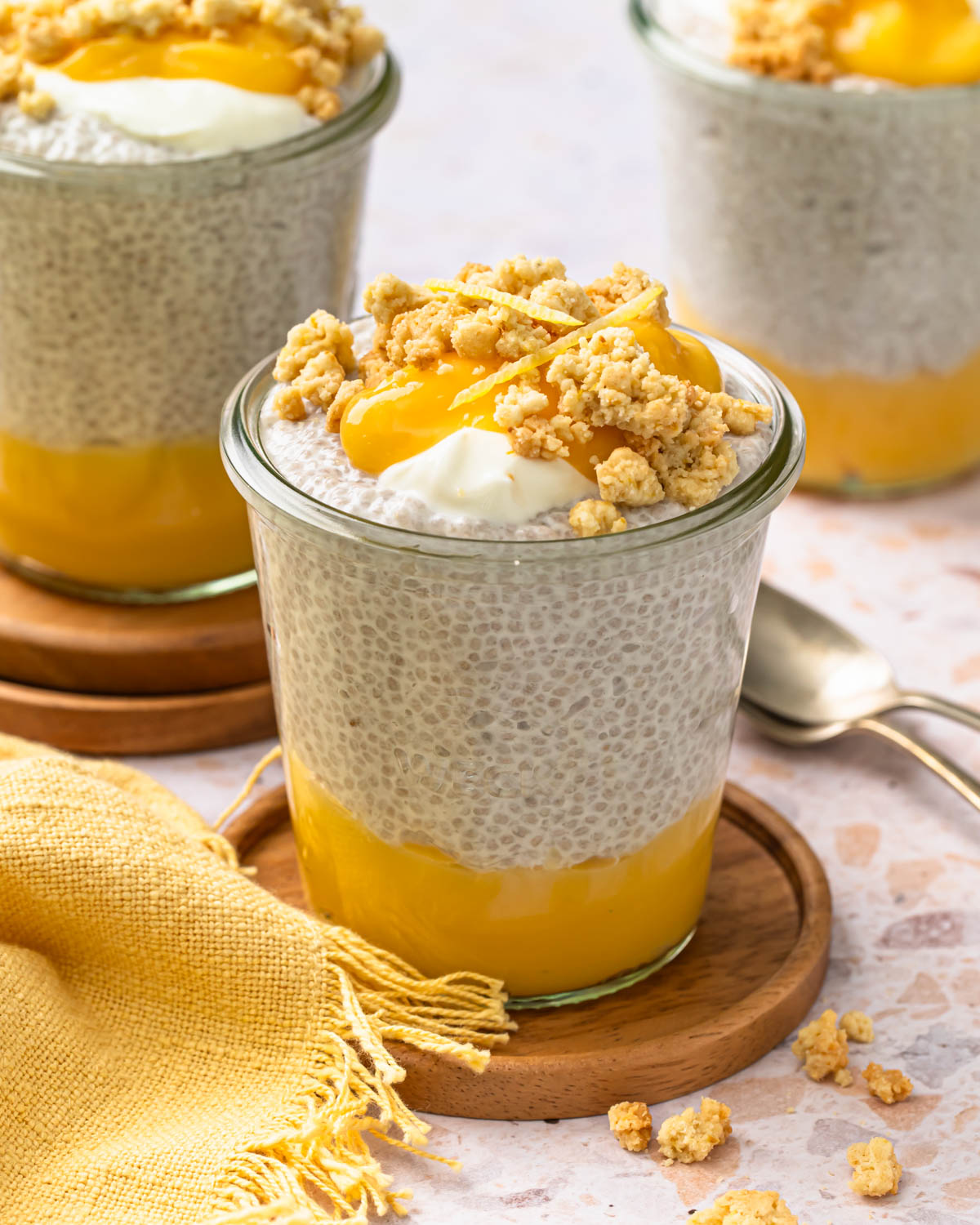 Lemon chia pudding with a layer of lemon curd and a golden crunch topping.
