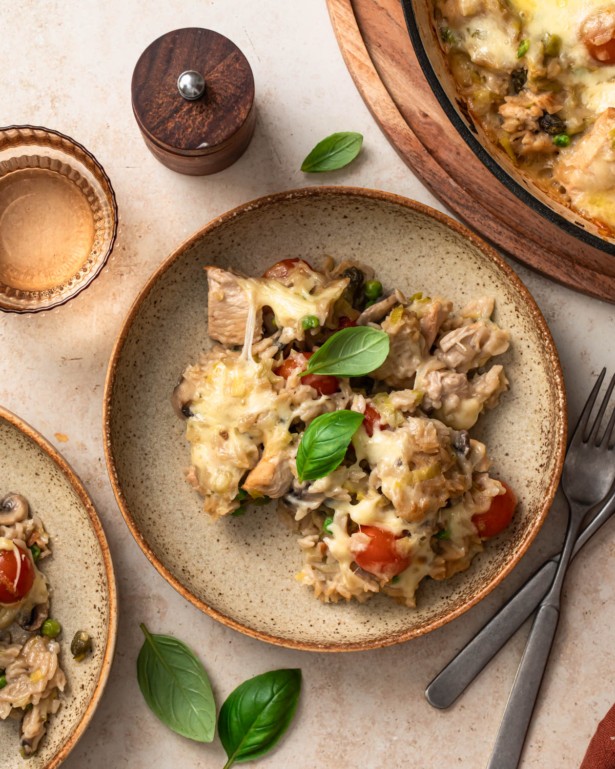 One pan chicken orzo pasta bake served in a bowl and topped with basil.