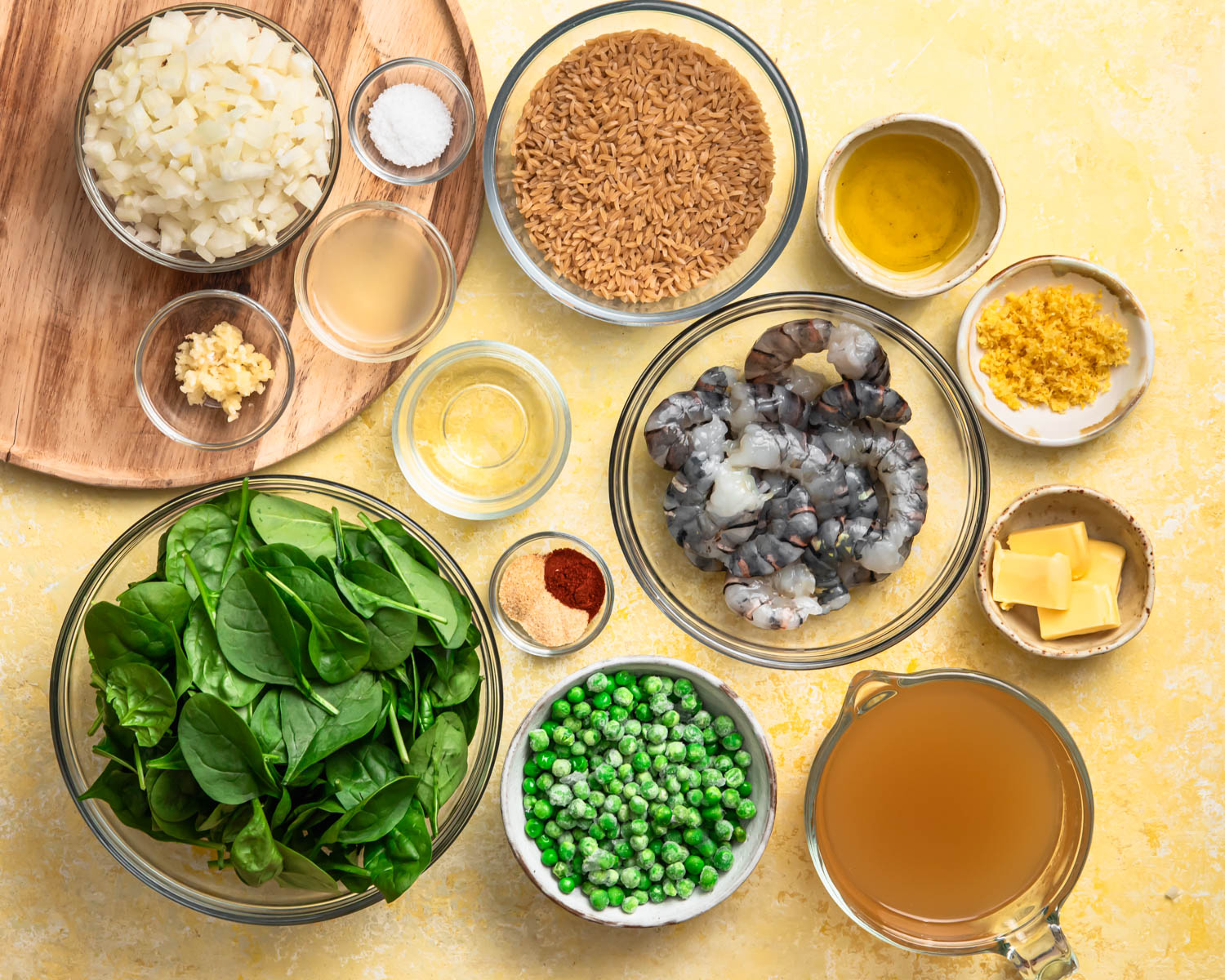 All of the ingredients for one pan lemon shrimp laid out in individual bowls.