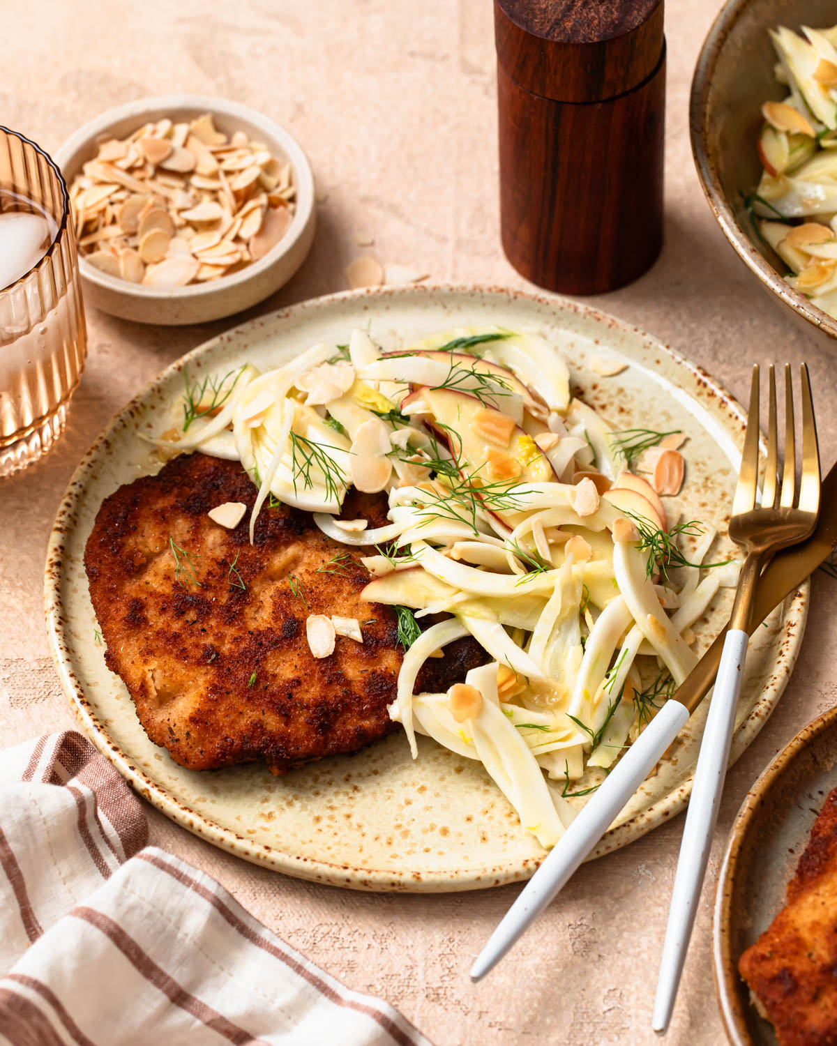 Front on photo of pork schnitzel with apple and fennel slaw.