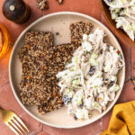 Cranberry walnut chicken salad served on a plate with some crackers.