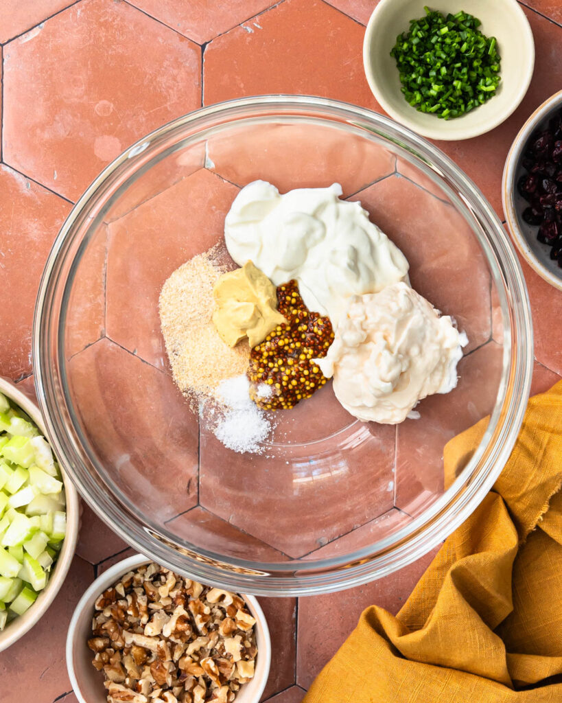 Cranberry walnut chicken salad dressing in a bowl before mixing.