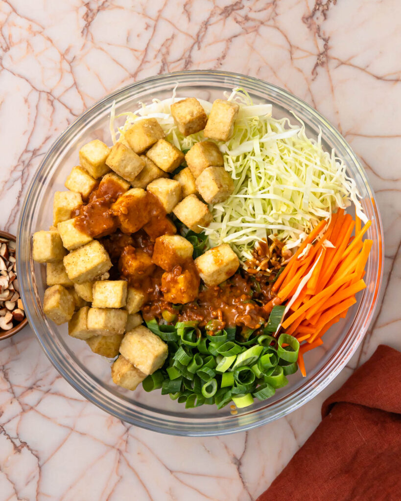 Dressing poured over the top of the tofu salad.