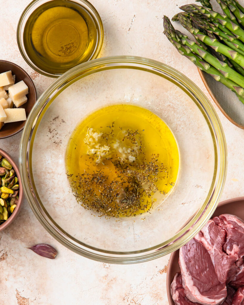 Olive oil, garlic, and spices in a mixing bowl.