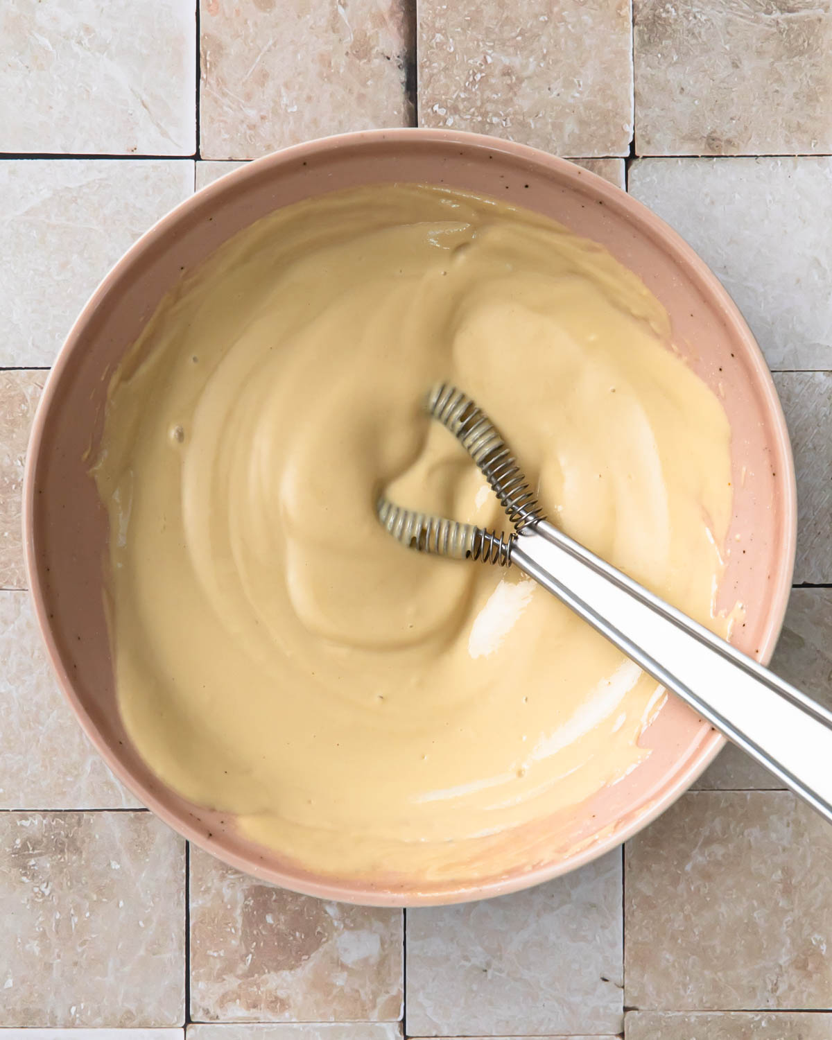 Tahini caesar dressing mixed together in a small bowl.