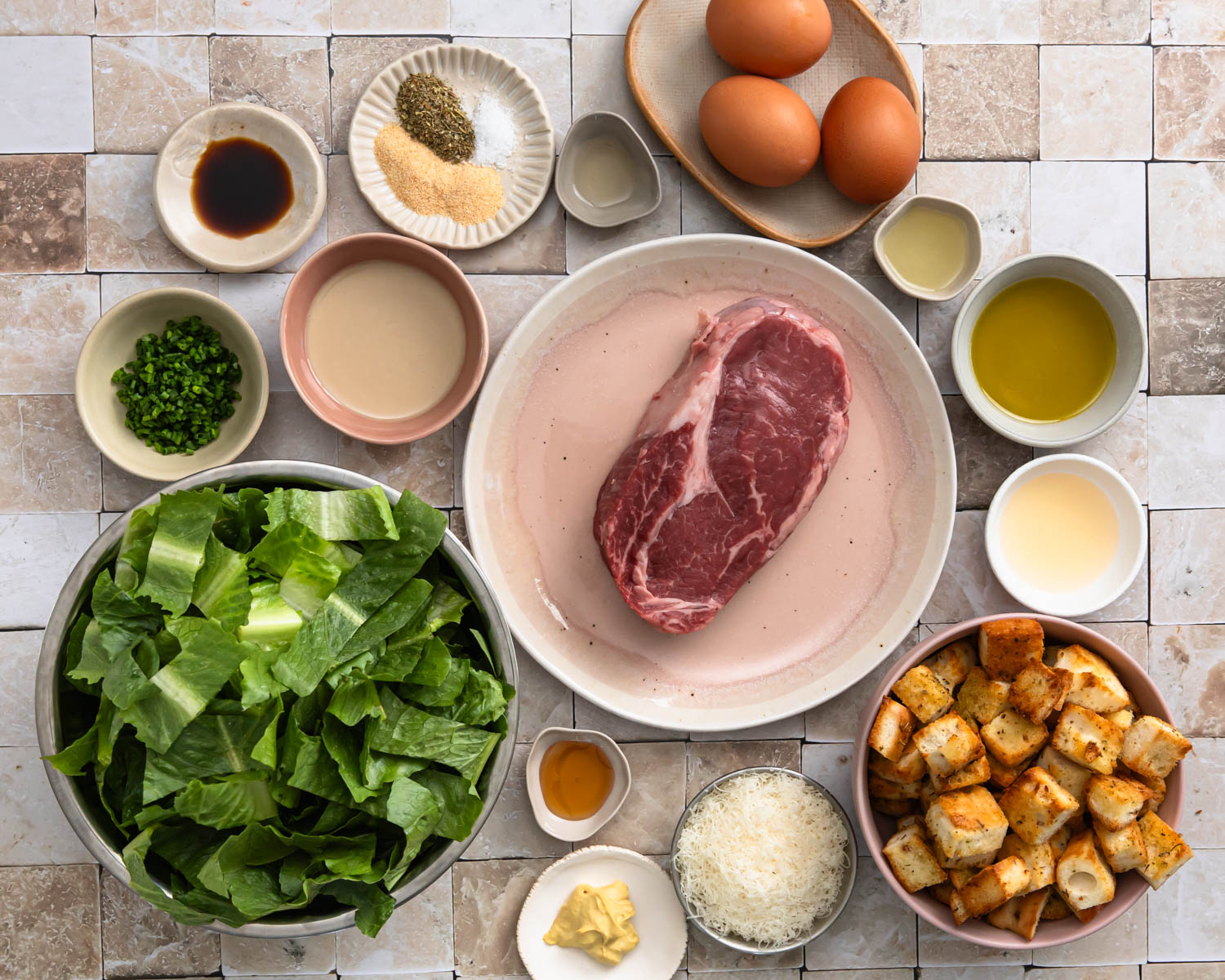 Ingredients needed to make steak caesar salad.