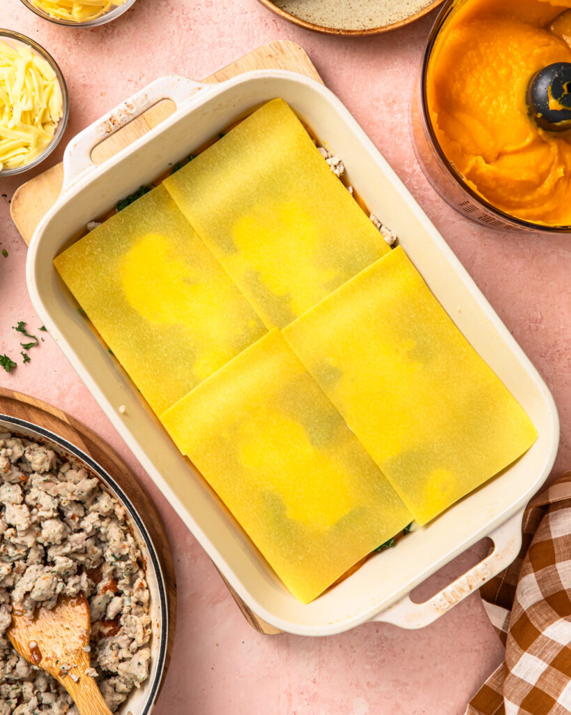 More sheets of lasagne pasta laid on top of the other layers of a butternut squash lasagne. 