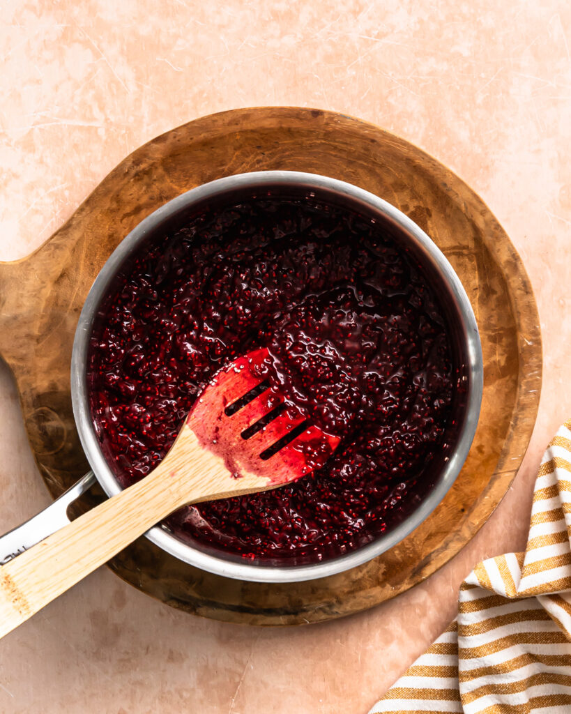Raspberry chia compote in a small saucepan.