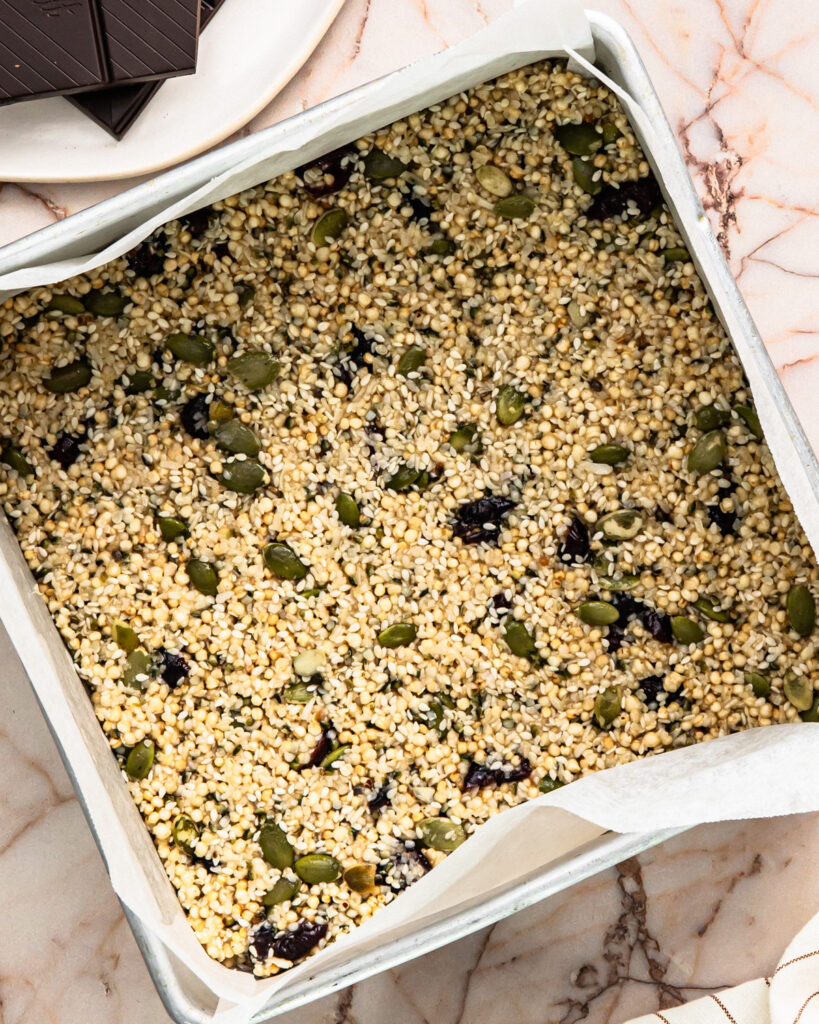 No bake energy bites mixture pressed into a tin. 
