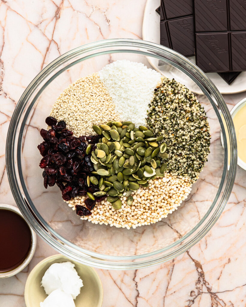 Ingredients for no bake energy bites added to a bowl. 