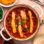 Salmon puttanesca in a pan.