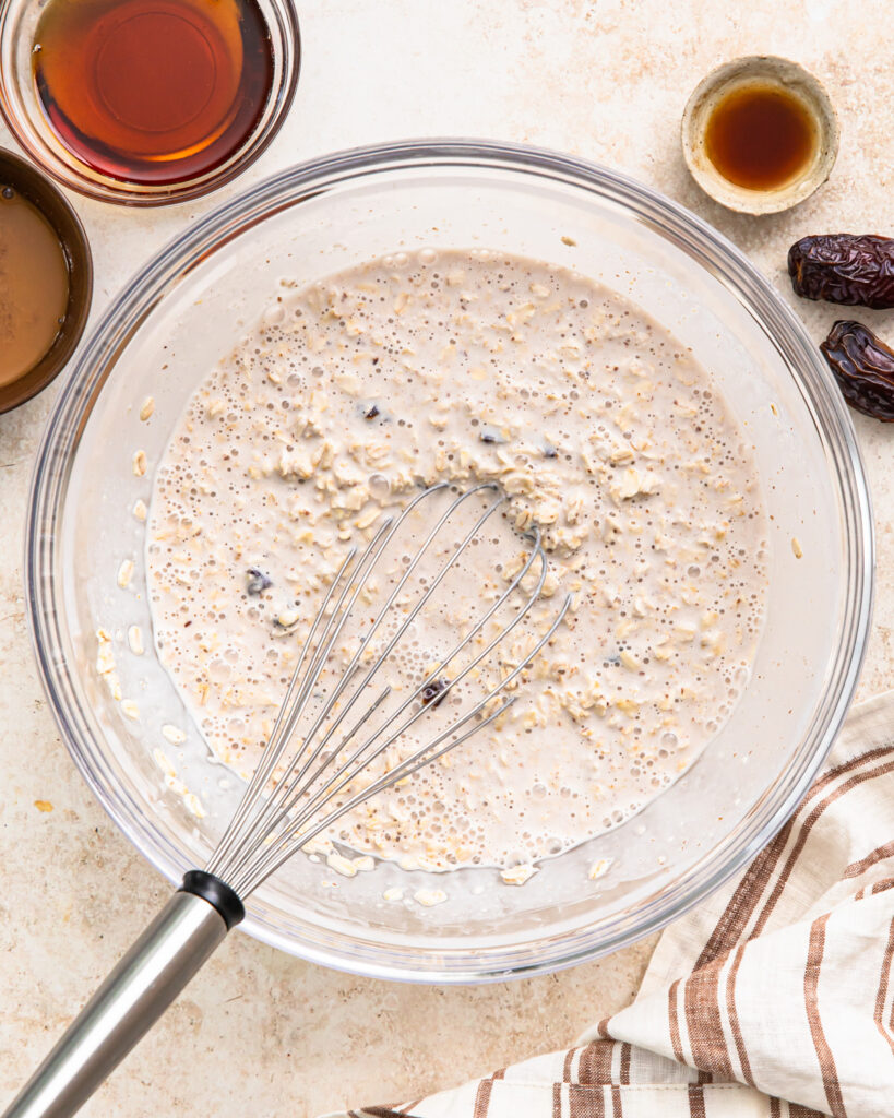 Date overnight oats mixture whisked together in a bowl.