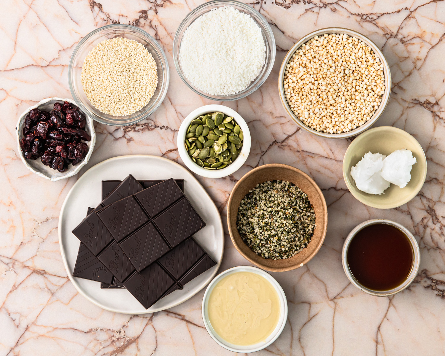 Ingredients for no bake energy bars laid out in bowls. 