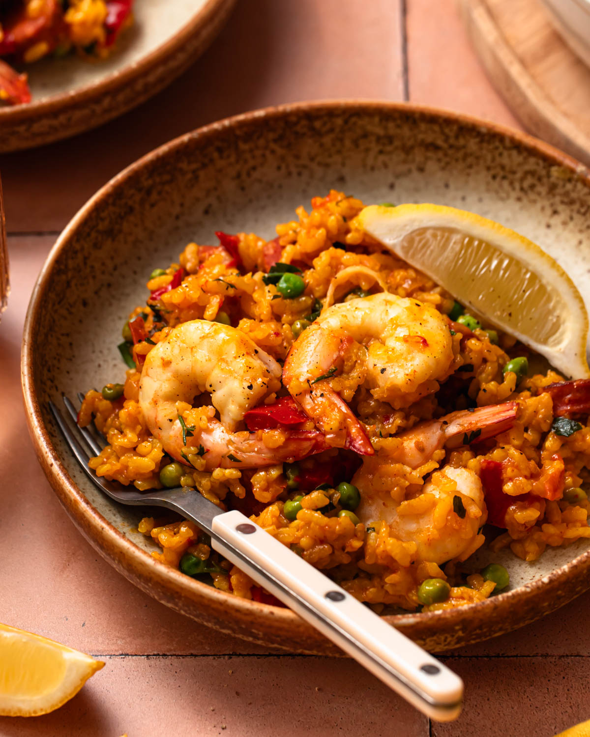 Close up of prawn chorizo paella in a bowl.